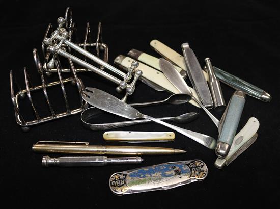 A silver bottle form cocktail swizzle, silver butter knife and fork, toast racks etc.